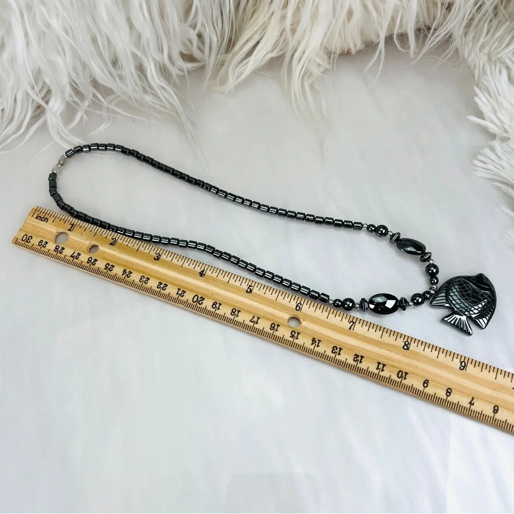 Beautiful weighted, gunmetal tone hematite necklace with fish pendant
